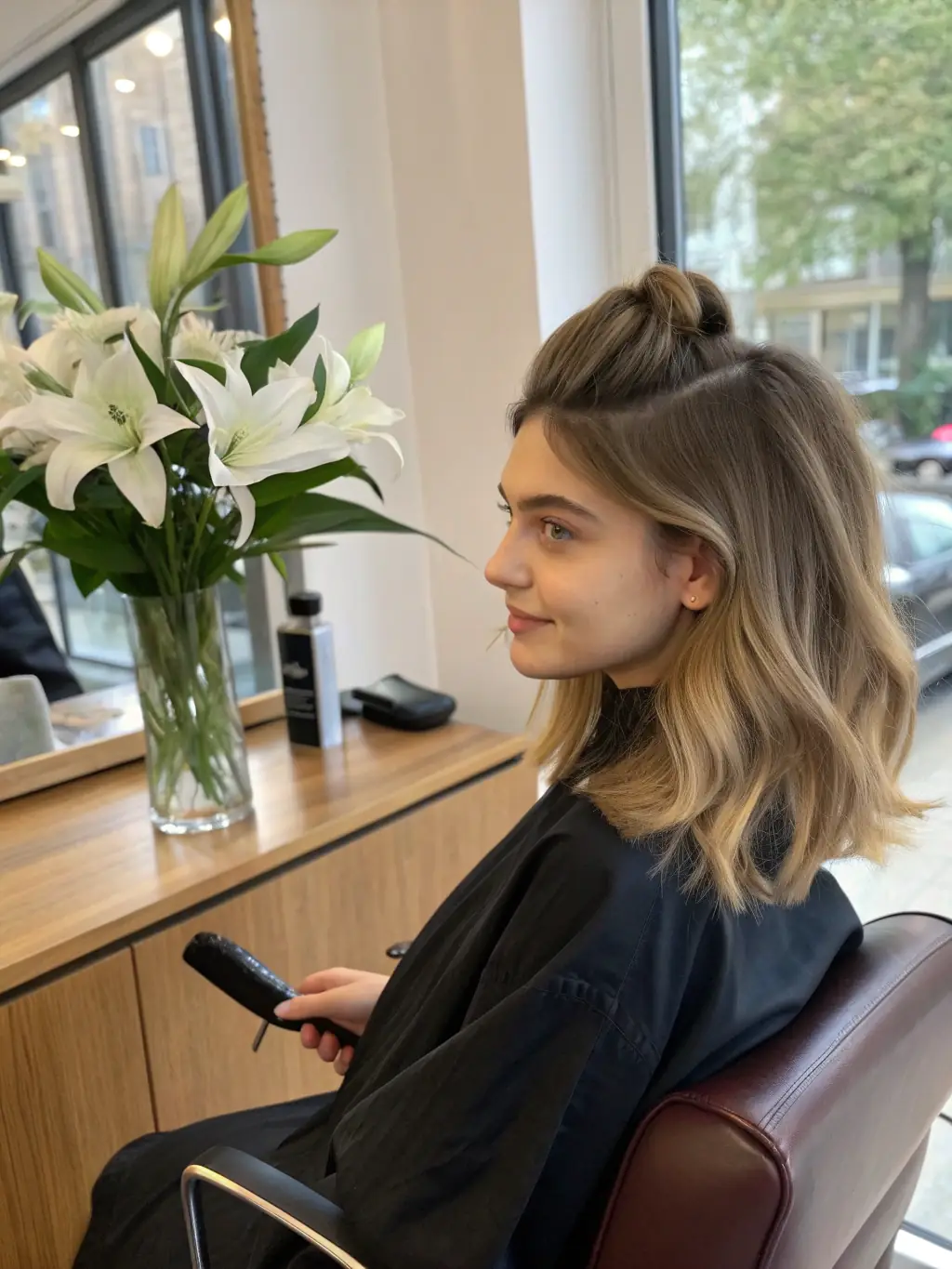 A woman with long, voluminous hair achieved with a topper, styled in a trendy way, demonstrating the natural look and versatility of toppers at The Collective Salon.